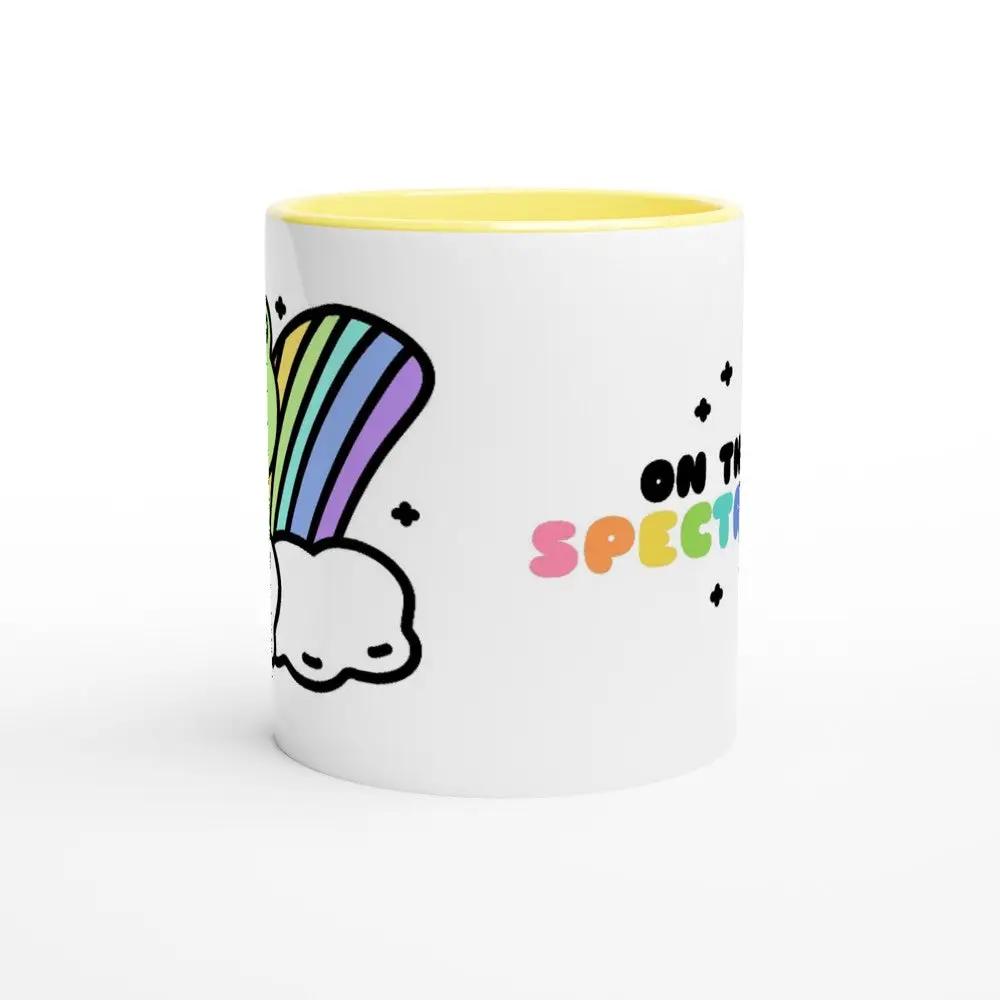 a white and yellow coffee mug with a rainbow on it