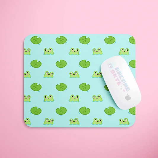 a mouse pad with a green frog pattern on it