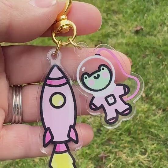 a person holding a keychain with a cartoon character on it