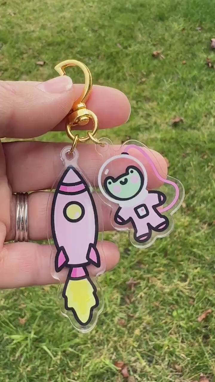 a person holding a keychain with a cartoon character on it