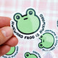 a person holding a sticker with a frog on it