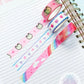 a spiral notebook with washi tape on top of it