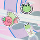 two stickers of a frog and a snail