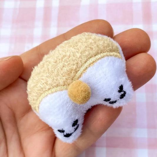 a person holding a small stuffed animal in their hand