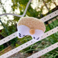 a teddy bear hanging from a white chair