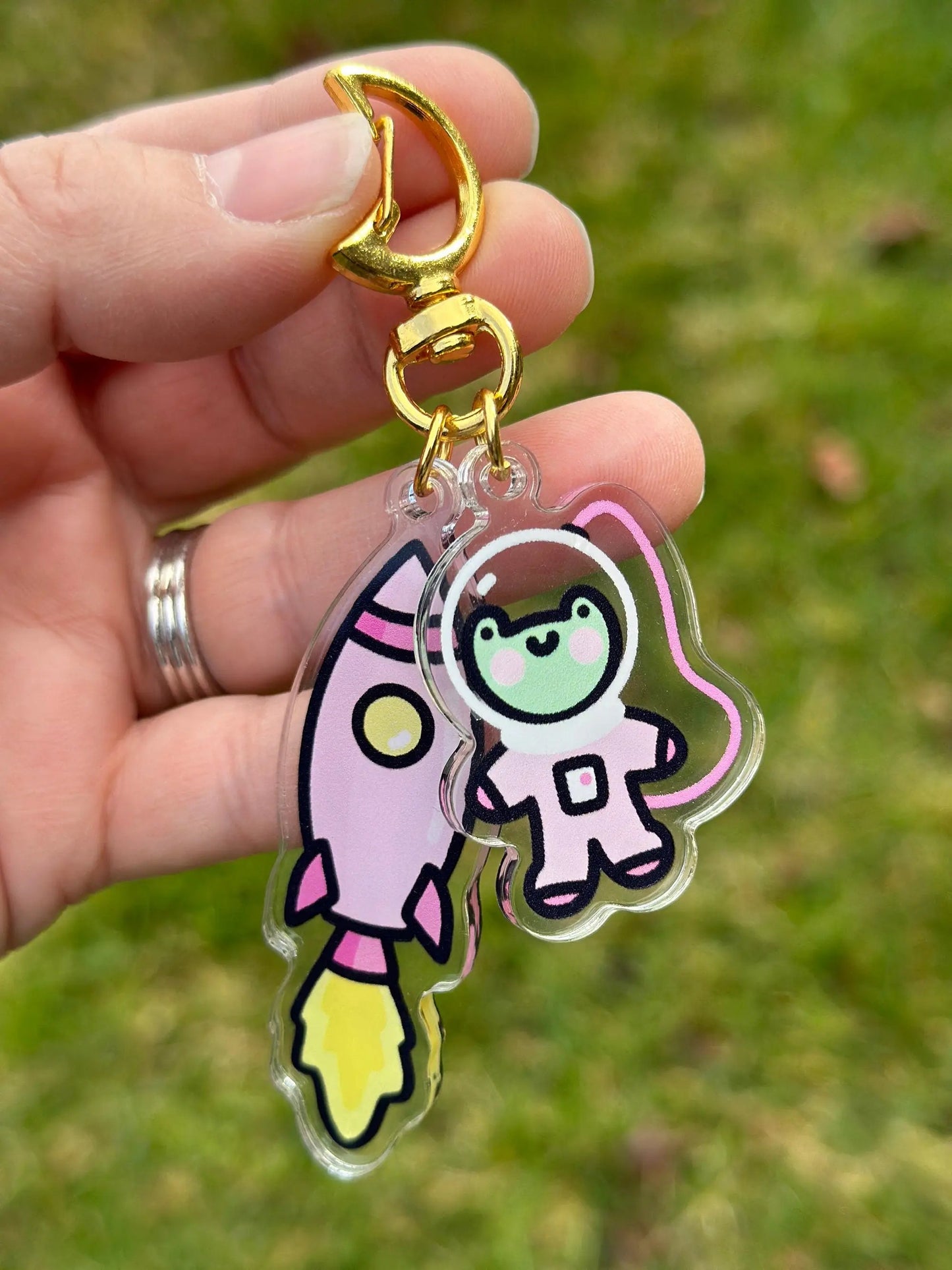 a person holding a keychain with a cartoon character on it